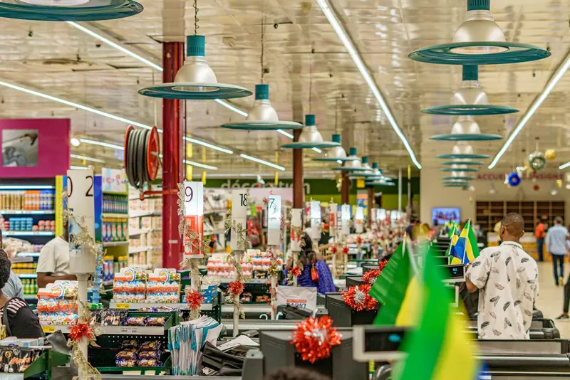 Shoppers in a bright supermarket aisle